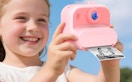 a little kid holding a pink camera