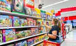 woman holding a lego building sets on a target shelf