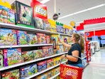 woman holding a lego building sets on a target shelf
