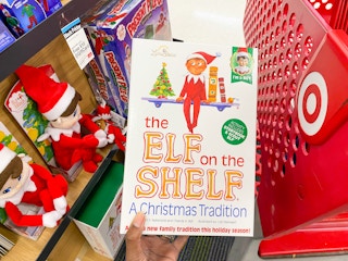 hand holding out elf on the shelf box in Target
