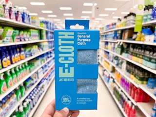 A hand holding an E-Cloth Microfiber General Purpose Cloth in the Target cleaning aisle