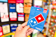 hand holding domino's gift card