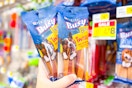 hand holding purina busy bones dog treats