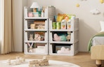 stacked organizers with items against a wall in a room