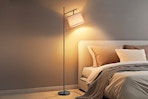 floor lamp over a bed