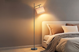 floor lamp over a bed