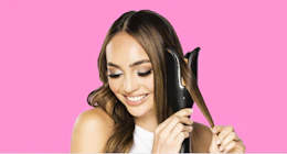 a woman holding a hair curler