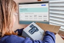 someone opening up a package from ebay with the ebay brand outlet on the computer