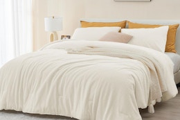 beige comforter on bed