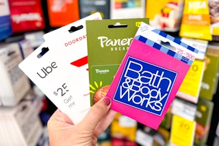 hand holding gift cards doordash panera bread uber bath and body works