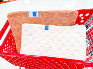 2 room essentials bath rugs sitting in a target cart