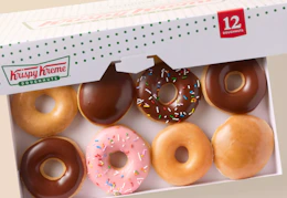 A box with a variety of different Krispy Kreme doughnuts inside.