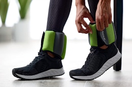 woman putting ankle weights on