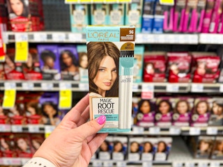 person holding loreal root rescue hair dye