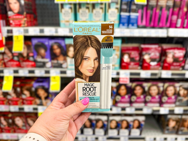 person holding loreal root rescue hair dye