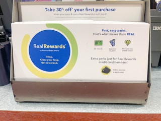 A sign for Real Rewards at the counter in an American Eagle store