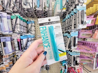 hand holding up a tube of wet n wild mascara