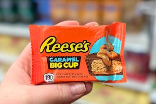 hand holding reese's caramel big cup candy