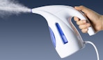 a hand holding a clothing steamer
