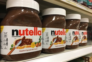 a row of Nutella jars on a shelf
