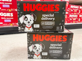 A couple of Huggies Special Delivery diapers sitting on a store floor with other diapers in the background.