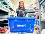 person holding a Walmart basket