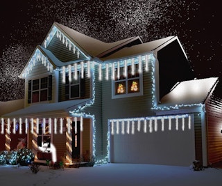 meteor Christmas lights on a house outside 