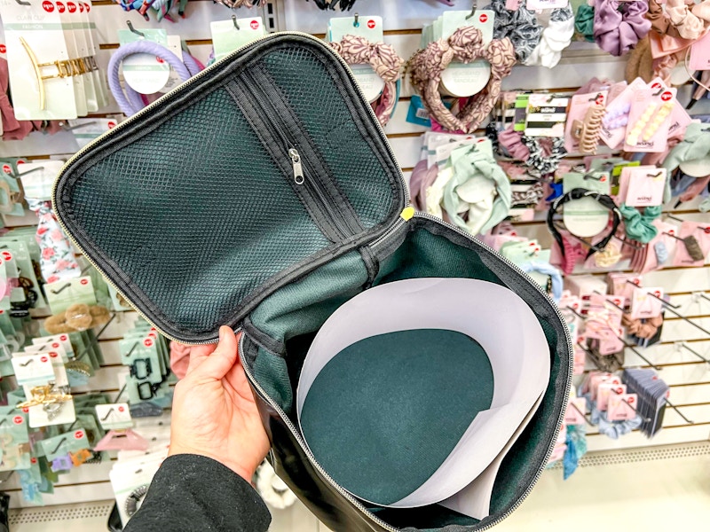 person holding open a large makeup bag