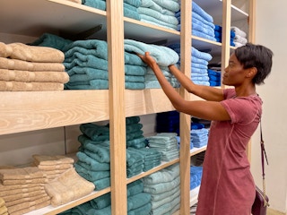 A person shopping in the towel section of Macy's