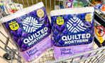 Two packs of Quilted Northern toilet paper in a shopping cart
