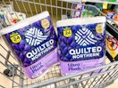 Two packs of Quilted Northern toilet paper in a shopping cart