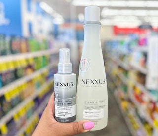 hand holding one Nexxus leave in conditioner and shampoo
