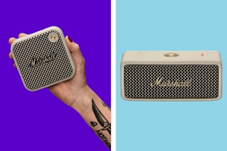 A hand holds a small Marshall bluetooth speaker. Another slightly larger Marshall bluetooth speaker