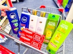 nivea men body wash, dove shampoo, garnier shampoo, and colgate toothpaste in a cart