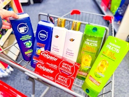 nivea men body wash, dove shampoo, garnier shampoo, and colgate toothpaste in a cart
