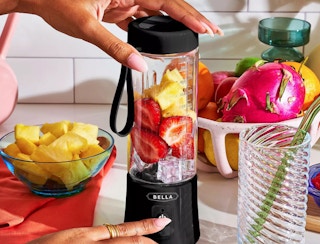 a portable blender with fruit inside