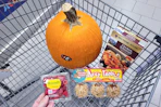 raspberries, caramel apples, schnitzel, and a pumpkin in a cart