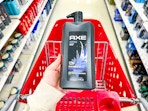 hand holding axe-32oz-body-wash over target cart