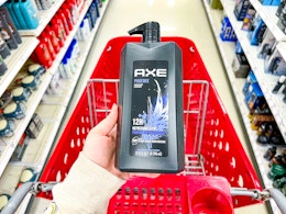 hand holding axe-32oz-body-wash over target cart