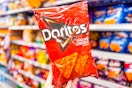 hand holding a bag of doritos