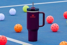 a stanley tumbler on a pickleball court
