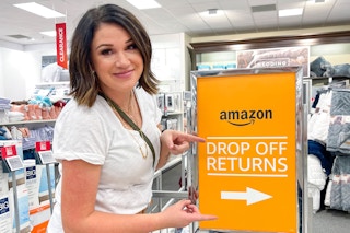 a woman pointing at an amazon drop off sign