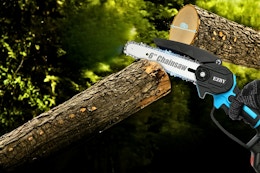 Lifestyle image if a mini chainsaw being used to cut down a tree branch