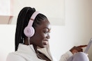 a woman wearing light pink Beats headphones