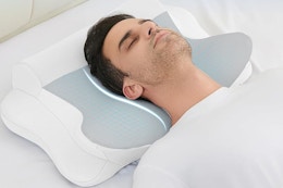 a man sleeping on a cervical neck pillow