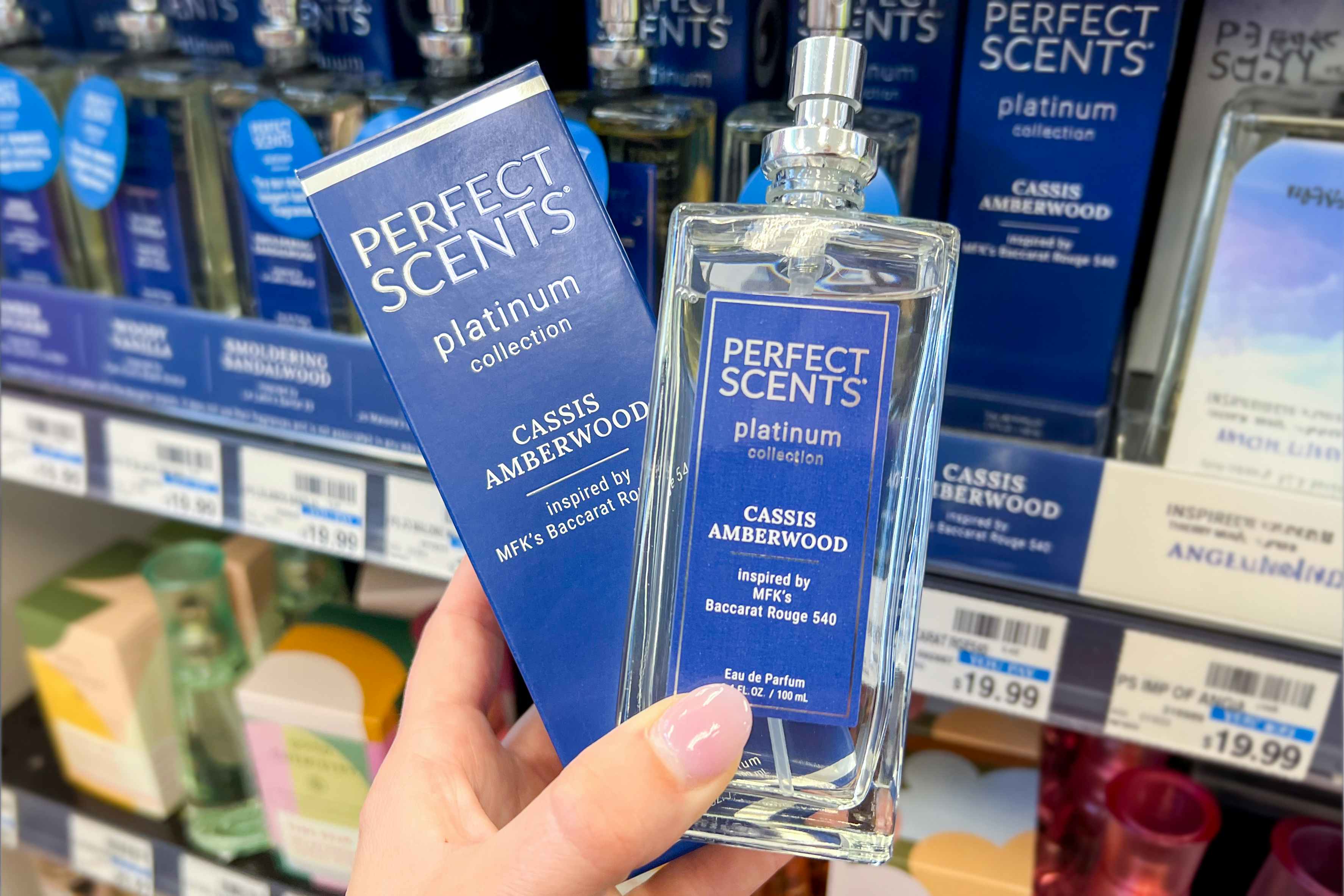 someone holding up some Perfect Scents perfume at CVS