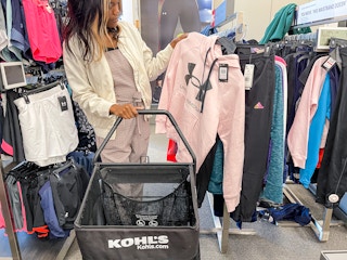 A woman shopping for under armour apparel at Kohls