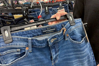 A woman holding Lucky Brand jeans.