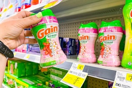 hand holding a bottle of gain tango scent booster at dollar general