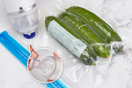 vacuum sealer being used on bag of cucumbers